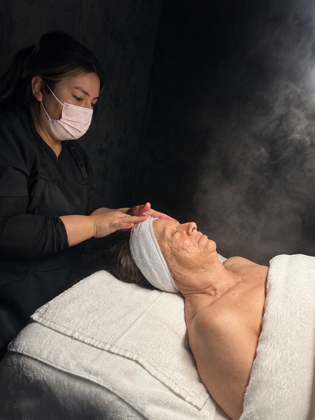 Cynthia performing a customized steam facial treatment at CYNNSBEAUTY in Tustin